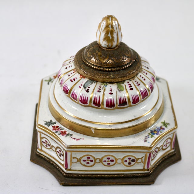 This object is an antique ormolu-mounted painted porcelain inkwell, designed or retailed by the renowned New York...