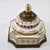 This object is an antique ormolu-mounted painted porcelain inkwell, designed or retailed by the renowned New York...