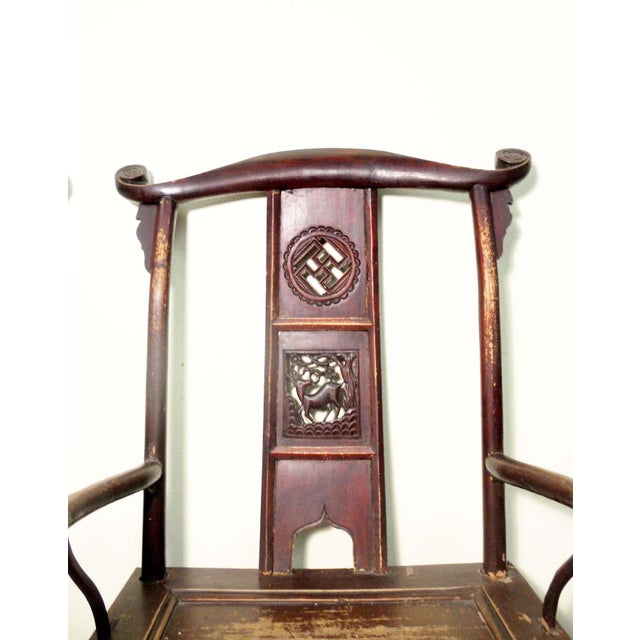 This style of chair is known as "official's hat chair" because the projections over the rear stiles resemble the knobs on...