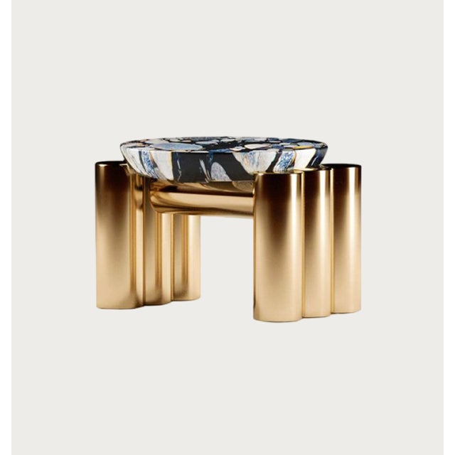 The table's shape mimics the arrangement of multiple layers within a single unit. The rhythm of the polished pipes gives...