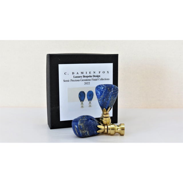 Deep blue gemstones with gold and white veining and light-catching detail. About 3" h. Gift boxed. Our Studio Exclusive 2022.