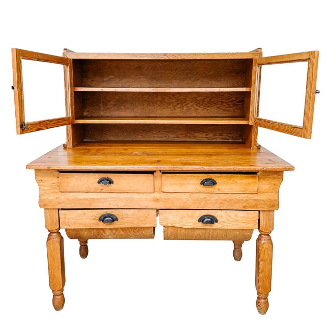 Mid to late 19th century American primitive "possum belly" handmade baker’s cabinet crafted from solid pine with a warm,...