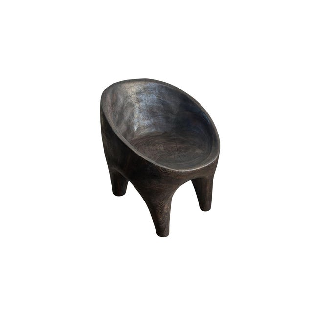 Handcrafted from solid suar wood by skilled artisans on the island of Bali, this sculptural chair blurs the line between...
