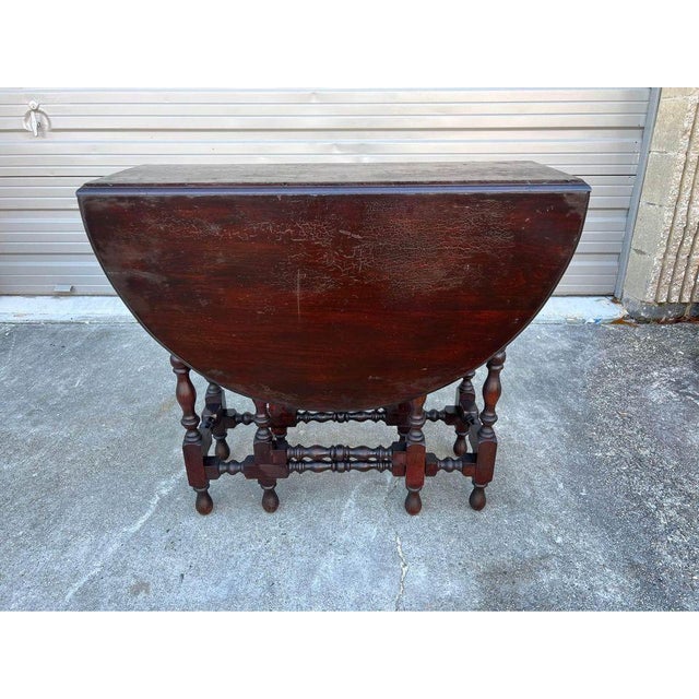 Antique English Walnut Gate Leg Dining Table. Solid wood , very heavy Featuring central panel, two drop leaves and carved...