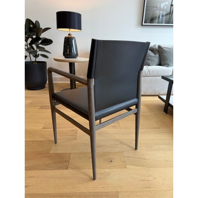 A refined “Ledermann” armchair designed by Tom Kelley for Enrico Pellizzoni, showcasing the brand’s signature...