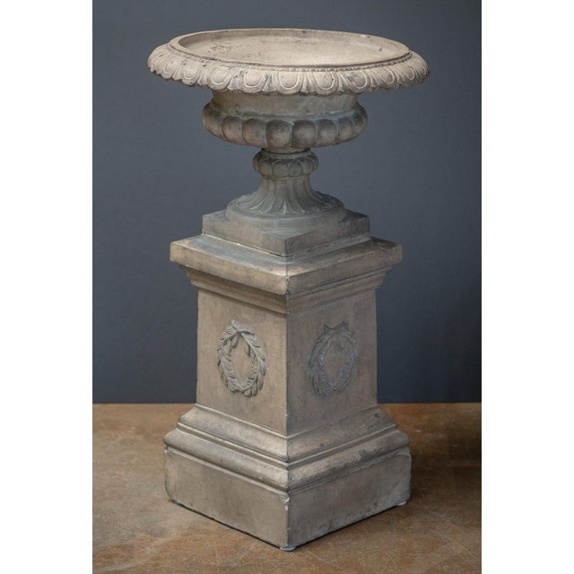 A fine large monumental English Campana garden urn (or planter pot) on plinth of buff terracotta, featuring a round urn...