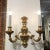 Pair of Carved wooden double light sconce in a distressed gold leaf finish. Created in Italy.