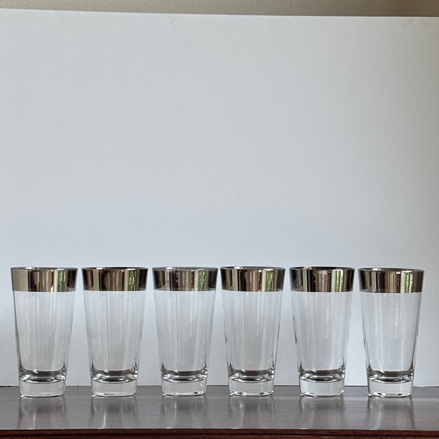 A stylish set of six vintage Dorothy Thorpe-style highball glasses featuring sleek silver-platinum bands encircling the...