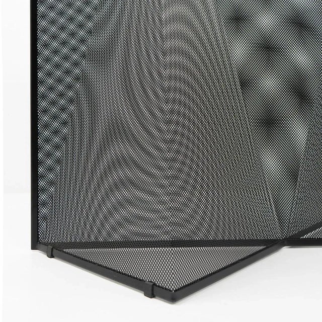 The room divider or paravent consists of two sheets of perforated metal bent into geometrical shapes. The structure gives...
