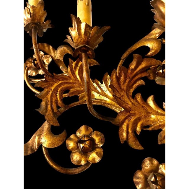 An exceptional and monumental seven-light wall sconce in gilt repoussé tole, italy, circa 1950. Executed in the louis xvi...