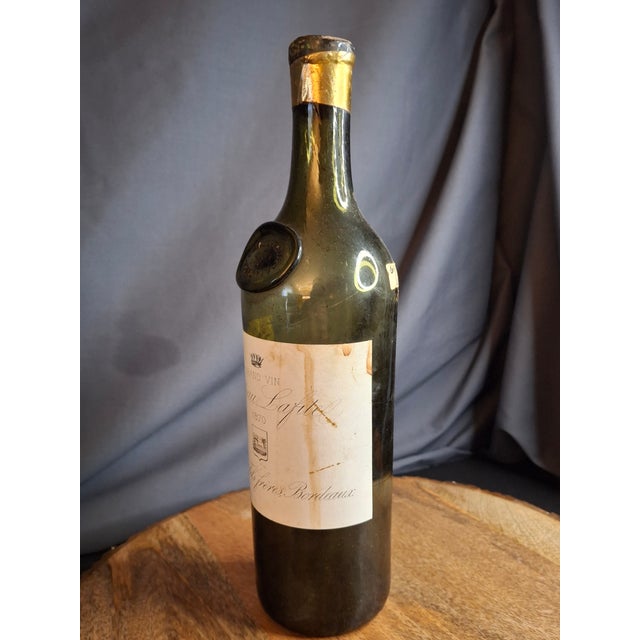 **This is an empty, secondary-market display piece.** This is a striking 19th-century hand-blown glass wine bottle, an...
