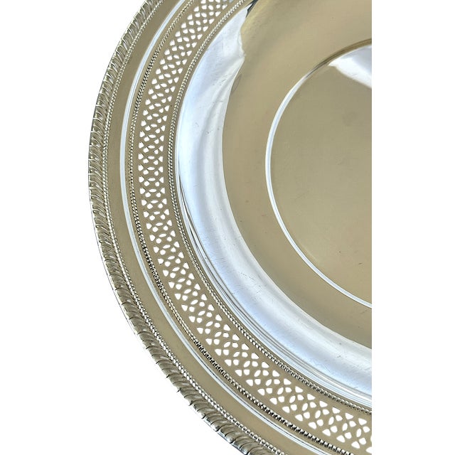 An elegant 1950s Cartier sterling silver tray featuring an exquisitely pierced gallery border, refined beaded detailing,...