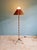 Mid-century brass floor lamp with a conical rattan shade, 1950s-60s. The floor lamp has been fully restored. It is...
