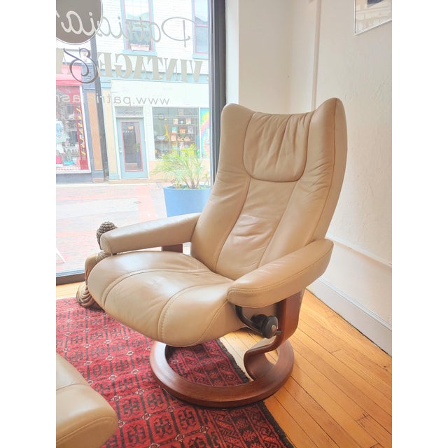 Here's a Classic Wing Stressless Ekhornes recliner and ottoman that features all leather upholstery and solid wood bases....