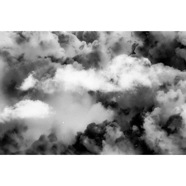 A restless sky, churning with unseen forces, moves in endless cycles of tension and release. Light and shadow collide,...