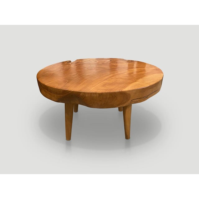 Impressive three inch reclaimed teak wood single slab coffee table. Floating on mid century style cone legs and finished...