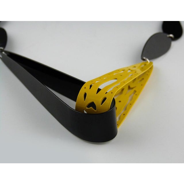 Graphic 2-dimensional teardrop chain-link forms connect to large 3-dimensional elongated loops. Hand cut by the artist...