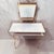 Classic 1970s Hollywood Regency two-tier makeup vanity table featuring an elegant gold-toned scrollwork frame, an...