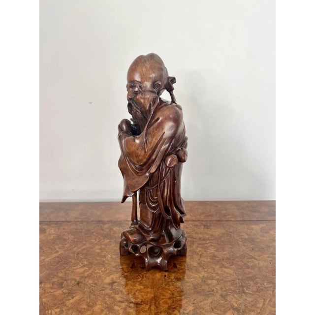 Fine quality large antique Chinese carved hardwood figure having a fine quality antique Chinese hardwood figure of a sage....