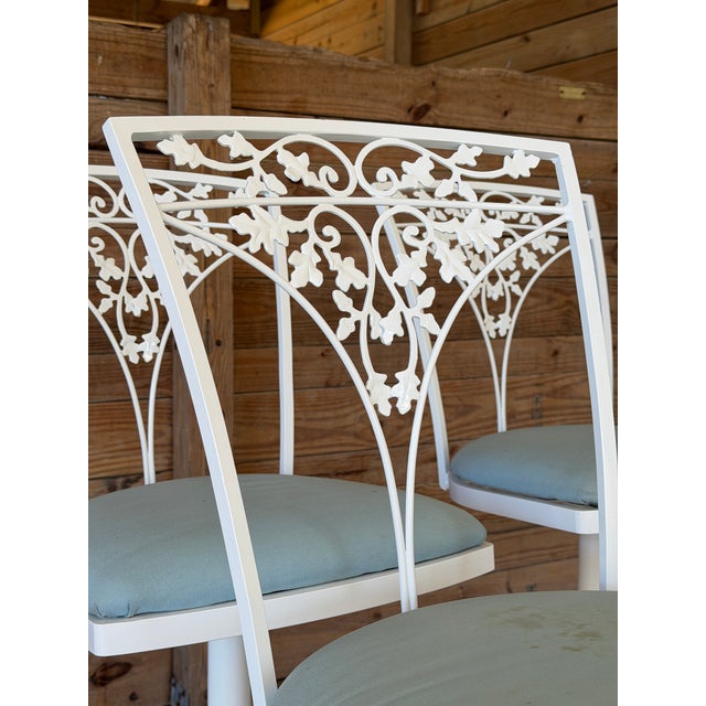 Charming set of vintage aluminum swivel counter stools by Woodard, featuring classic ivy leaf and scrolling vine backs—an...