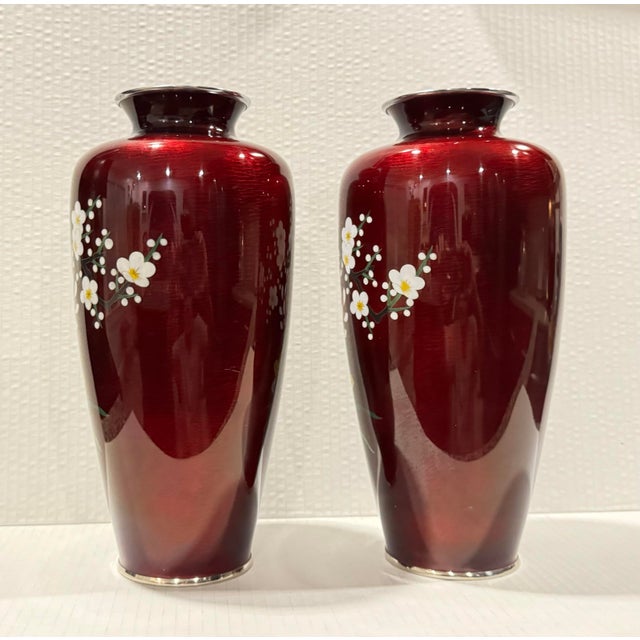 The chrysanthemums, a symbol of longevity and imperial heritage in Japan, are rendered in delicate wireless cloisonné, a...