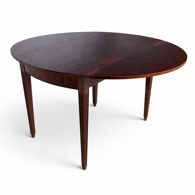 A charming antique mahogany drop-leaf table, beautifully proportioned and ideal for compact spaces. This versatile piece...