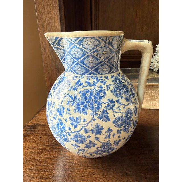 This authentic 19th-century English transferware pitcher by W. Ridgway of Hanley, Staffordshire features an elegant blue...