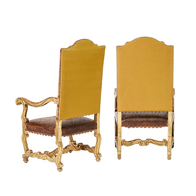 A pair of Italian tooled leather and gilt armchairs in the Baroque / Louis XIV style. mid to late 18th Century. This...