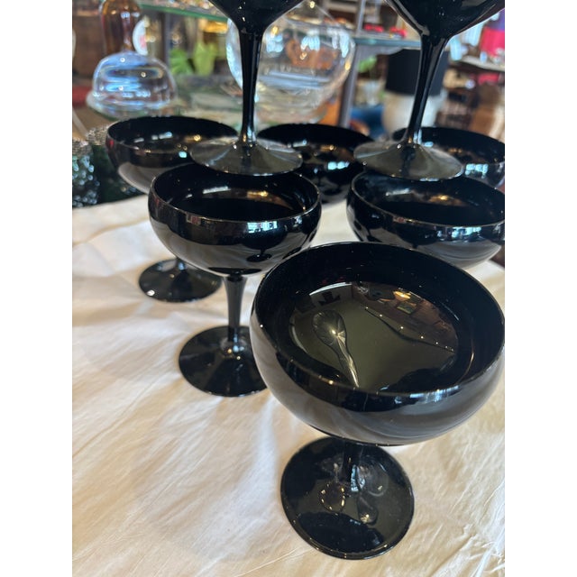 Striking champagne coupes in opaque, black glass with no chips, cracks or wear. Classic coupe form.