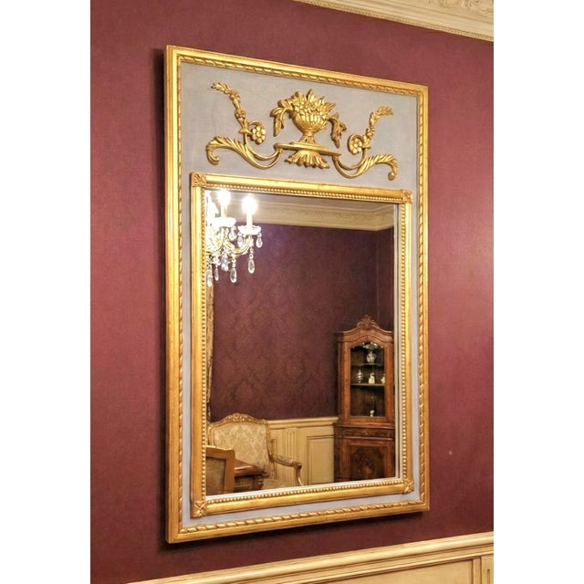 Elegant 19th-century French giltwood mirror in the Neoclassical / Empire Revival style. Features a finely carved and...