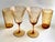 A beautiful set of four vintage Cambridge Glass drinking glasses in warm amber, decorated with the company's elegant Etch...