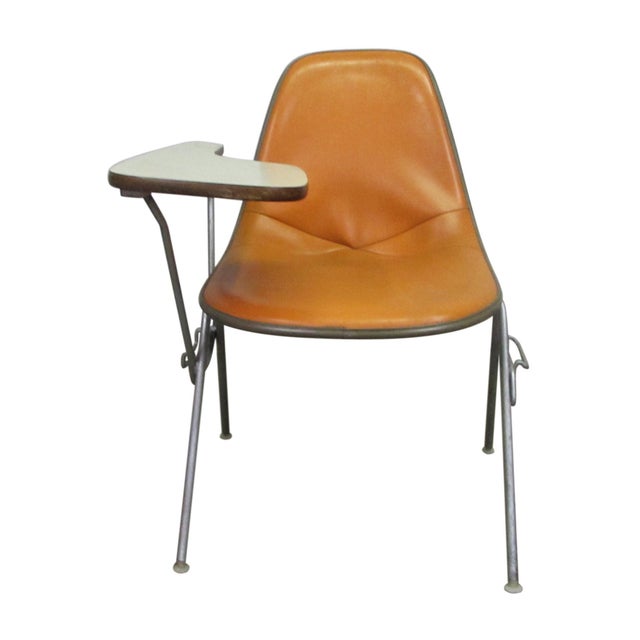 Classy yet comfortable bucket style school chair with adjustable side desk. Orange vinyl upholstery and tubular brushed...