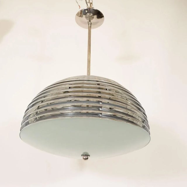 Space-age polished nickel pendant with frosted glass shade. Origin: Japan Circa: 1960s Dimensions: 13" high , 21" diameter...