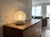 A 1970s murano glass lamp. Its enveloping spherical shape is crafted from the highest quality murano glass, featuring a...