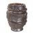 This sculptural ceramic piece features a rugged, layered texture that mimics the strata of ancient rock formations or...
