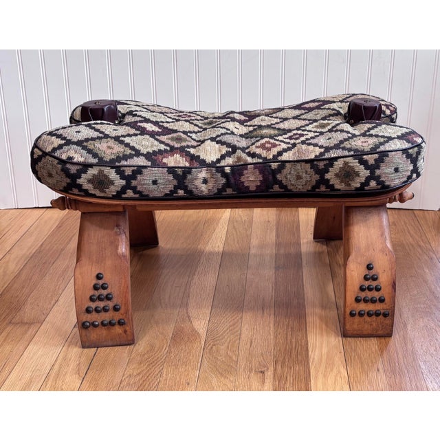 Rustic Moroccan vintage camel bentwood saddle, with a detachable cushion, brass/leather knobs and straps. The cushion is...