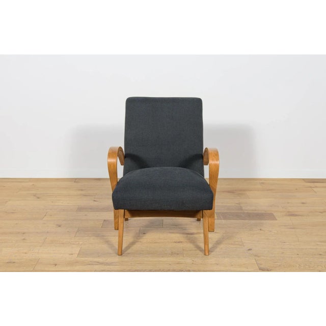 The Czechoslovak armchair was produced in the 1960s. The wooden elements have been cleaned, painted with oak-colored...