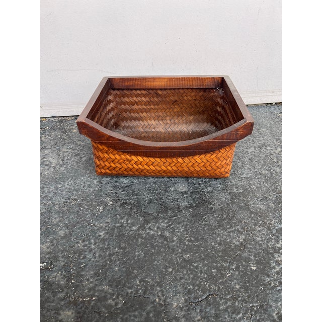 This wicker basket appears to be a Japanese Mid-Century Ikebana bamboo basket produced in the 1950s. It is designed for...