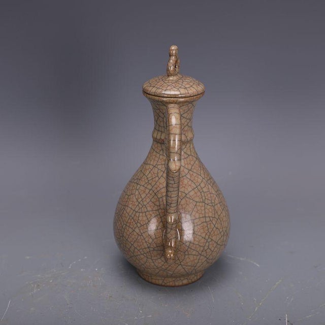 This striking ceramic ewer is a beautiful example of traditional Chinese-inspired pottery, characterized by its...