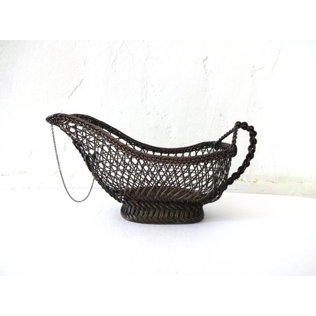 An antique French silverplate wine bottle holder in an open basket weave, with a rope link handle -- rare at the back...
