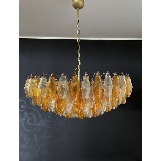 Elegant Italian pendant light made from 185 multicolored Murano glasses "poliedri". Structure in gold and brass colored...