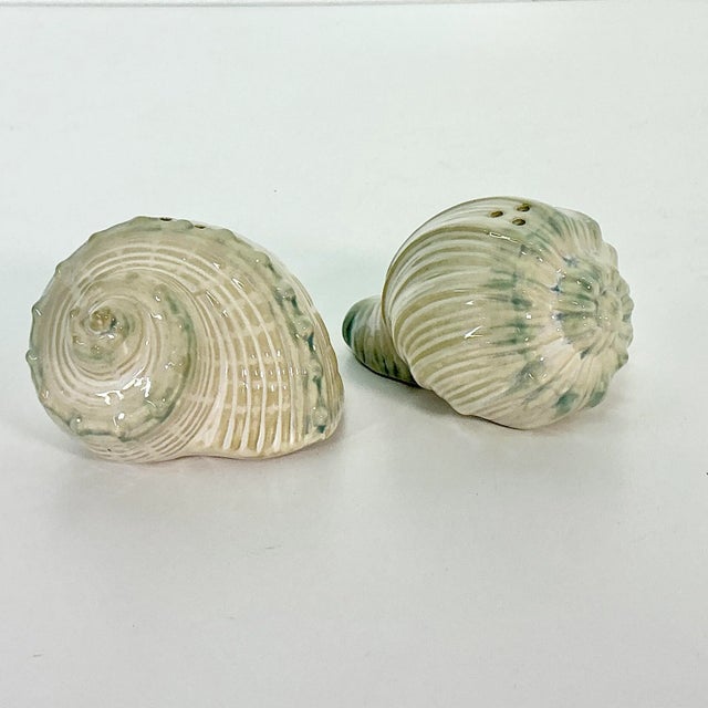 This is a lovely pair of Trompe L’Oeil Sea Shell Salt and Pepper Shakers. The ceramic pair are in two sea shell shapes in...
