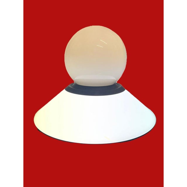 large space-age lamp in white opaline glass, steel, and a mamro base dual light function: both the bottom disc and the top...