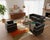 Matching set includes one three-seat sofa and two armchairs upholstered in black leather with polished chrome tubular...