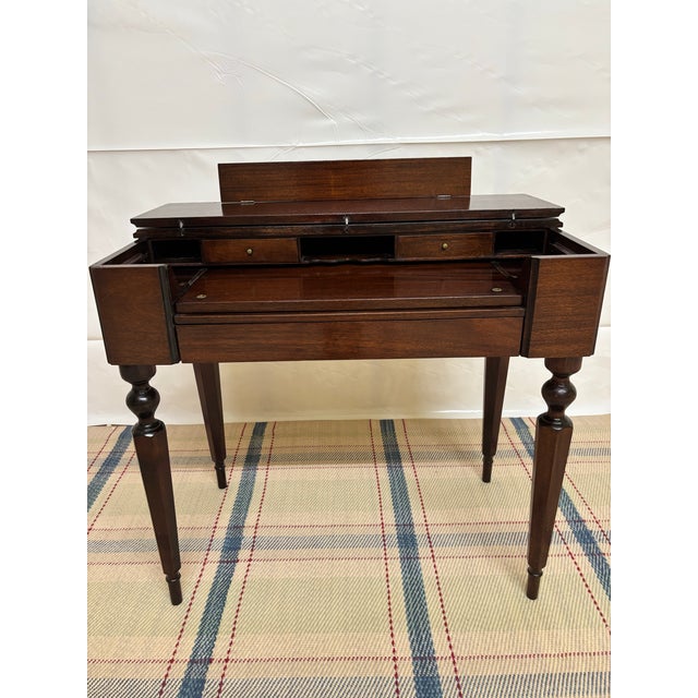Solid Mahogany spinet-style writing desk, manufactured by the Colonial Manufacturing Company, dating to the early 20th...