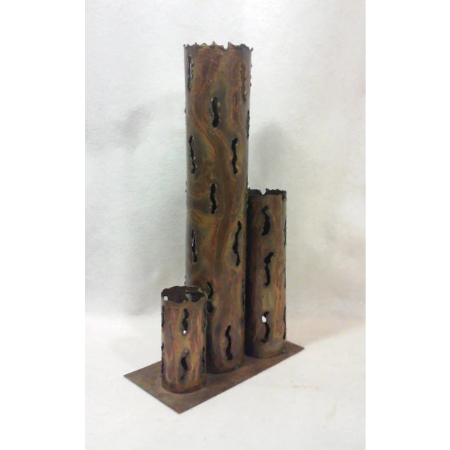 A spectacular tall Brutalist style decorative sculptural torch cut metal vase with a variegated finish in shades of brass,...