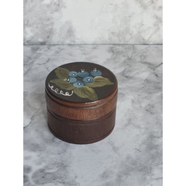 Beautifully painted flowers on a round, wood turned trinket box with lid. This would be a great accent piece in an office...