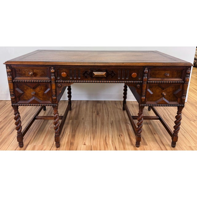 Handsome antique Jacobean style desk with barley twist legs, removable glass top, and elaborately carved burled wood...