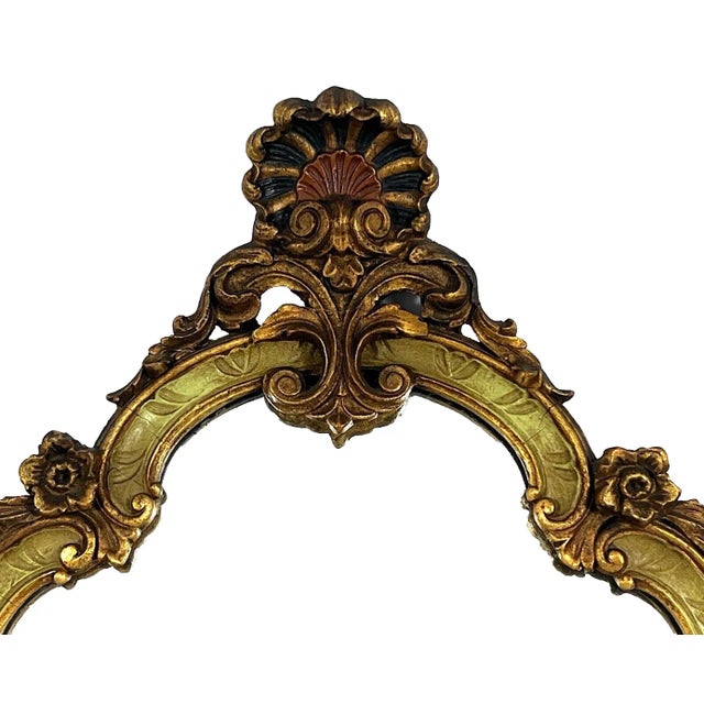 Antique gilt wood wall mirror from the 1920-40s, gold with gentle hints of soft olive green on the carved wood surround....