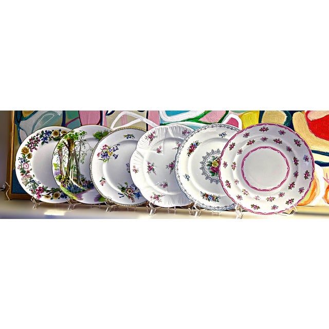 Six Shelley Fine Bone China floral and scenic design plates made in England. Each plate is unique in pattern and all...